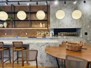 Ambiente interno moderno com mesa de madeira e parede de concreto.