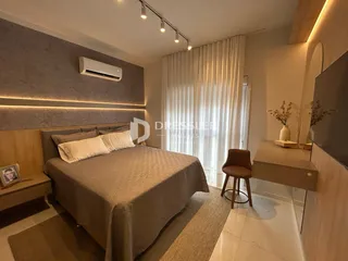 Quarto com cama e decoração moderna em um imóvel no Brasil.