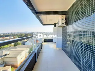 Vista de uma varanda com piso de cerâmica e vista panorâmica da paisagem urbana.