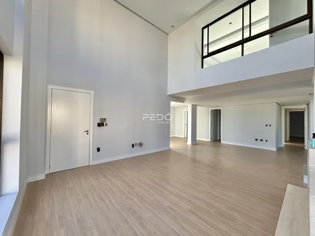 Hall de entrada de um imóvel moderno com piso de madeira clara.