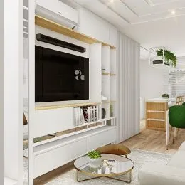 Sala de estar moderna com painel de TV e estantes brancas em um imóvel.