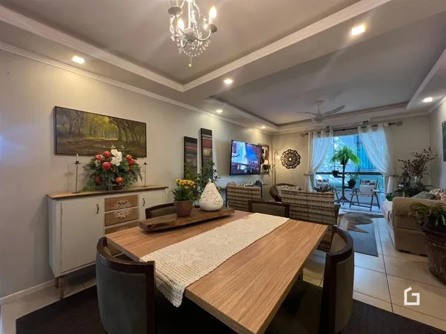 Sala de estar e jantar com decoração moderna e iluminação clara.