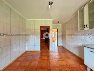 Hall de corredor com piso de tijolos vermelhos.