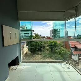 Vista externa mostrando vegetação e edifícios distantes da propriedade.