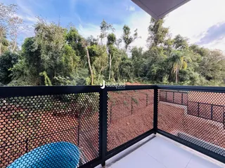 Vista da paisagem de mata densa a partir de uma varanda.