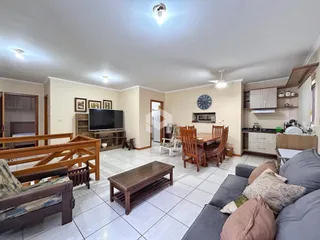 Sala de estar com móveis de madeira e piso cerâmico.