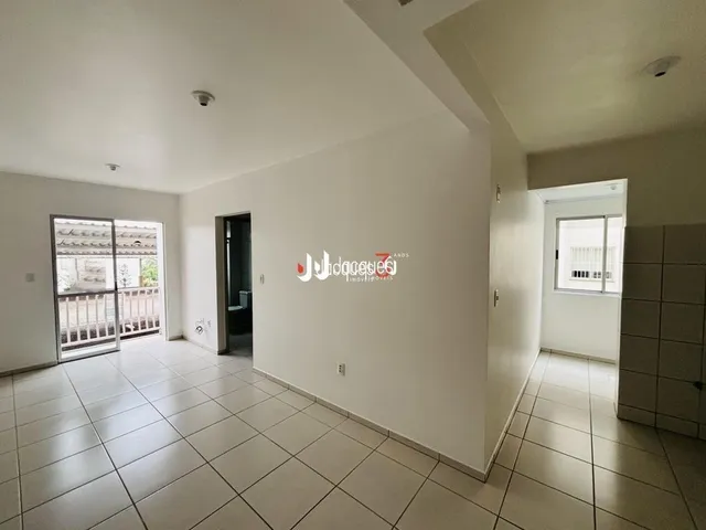 Foto de um corredor interno com piso de cerâmica clara.