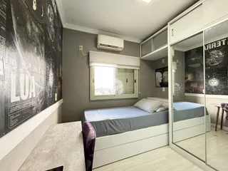 Quarto com cama e armário espelhado em um imóvel no Brasil.