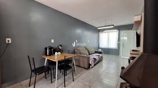 Sala de estar com sofá e mesa de jantar em um apartamento.