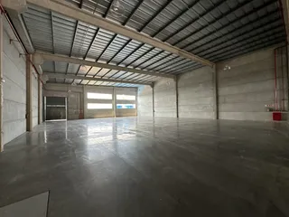 Espaço industrial amplo com piso de concreto polido.