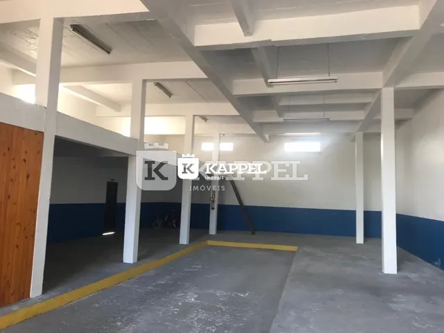 Hall de entrada com estrutura de vigas expostas e paredes azuis.