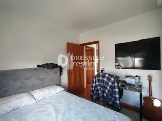 Quarto com cama e parede branca.
