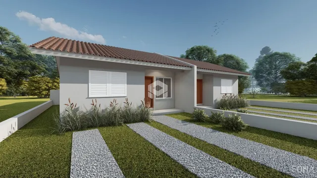Fachada de uma casa residencial com jardim e caminho de pedras em Lajeado.