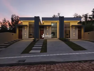Fachada moderna de uma casa em Lajeado, Brasil, com jardim e entrada pavimentada.