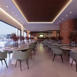 Vista de um espaço de jantar com mesas longas e cadeiras em um apartamento.