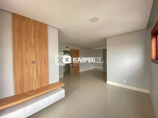 Hall de entrada com piso claro e porta de madeira.
