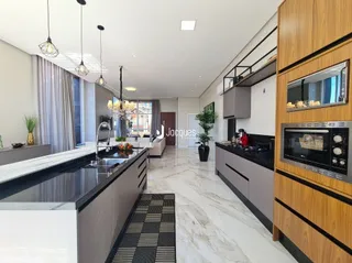 Interior de uma sala de estar moderna com piso de mármore e armários de cozinha.