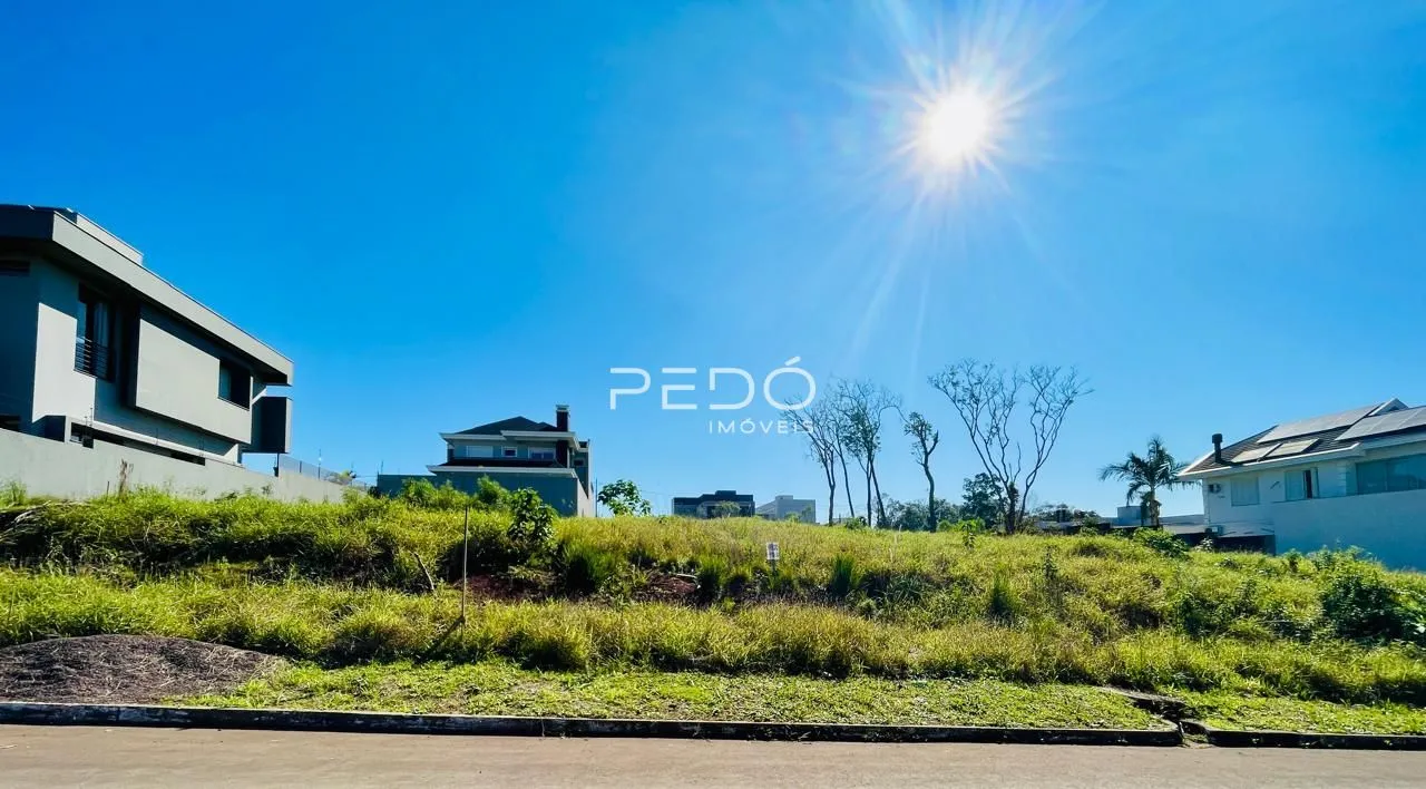 Vista externa de uma propriedade com vegetação verde no primeiro plano.