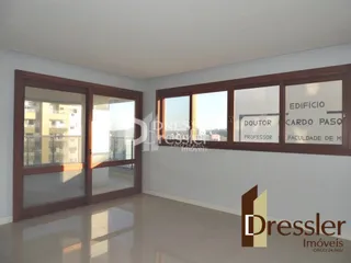 Vista da sala com grandes janelas de madeira em um imóvel em Lajeado.