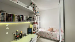 Quarto com cama e prateleiras brancas em um ambiente claro.