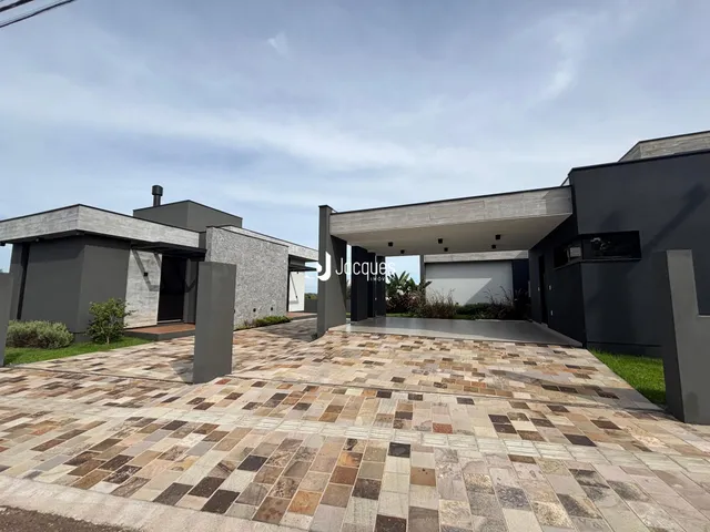 Fachada moderna de uma residência em Lajeado, Brasil, com área externa pavimentada.