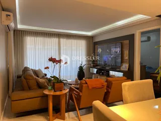 Sala de estar com sofá e poltronas em ambiente claro.