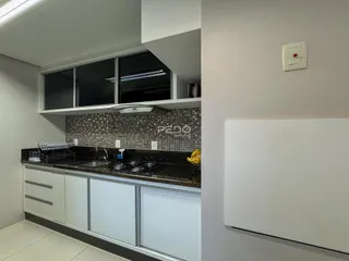 Cozinha moderna com armários brancos e revestimento de azulejos na Lajeado.