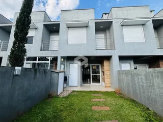 Fachada de um prédio residencial em Lajeado, Brasil, com jardim frontal.