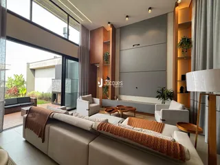 Sala de estar moderna com grandes janelas que dão vista para o exterior.