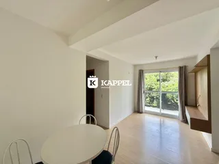 Foto de um ambiente interno com mesa de jantar e piso de madeira clara.