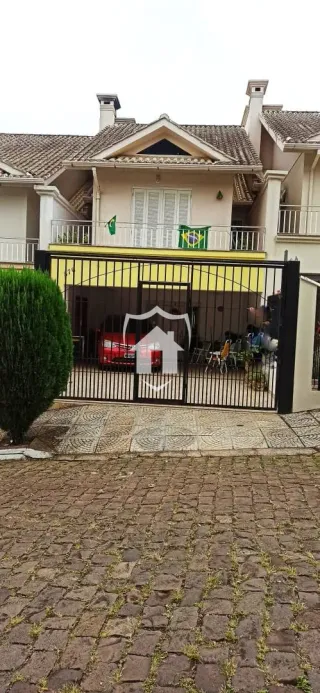 Fachada de uma casa em Lajeado, Brasil, com portão de ferro.