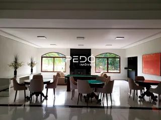 Sala de jantar com mesa de madeira em ambiente claro.