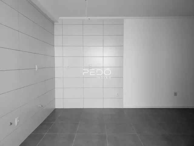 Imagem de um ambiente interno com paredes brancas e piso de cerâmica.