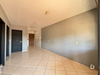 Corredor interno de uma residência com piso de cerâmica.
