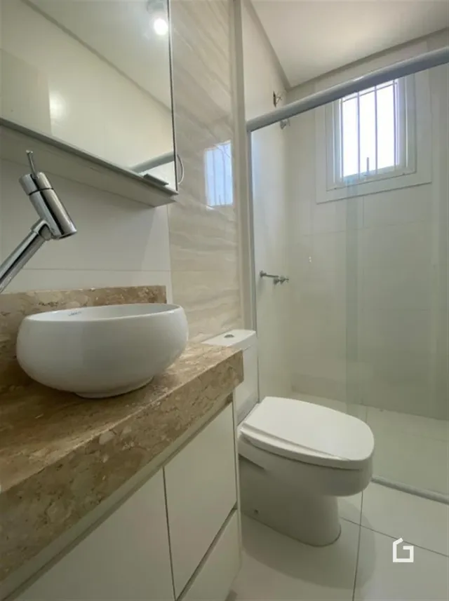 Foto de um banheiro moderno com pia e vaso sanitário.