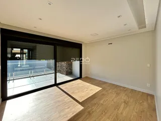Sala de estar com porta de vidro abrindo para a área externa.