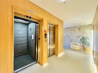 Corredor interno com acesso a elevadores em uma residência.