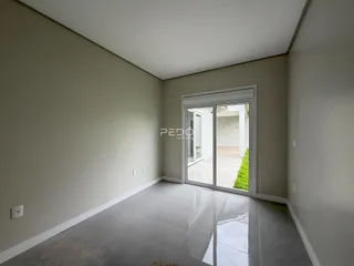 Vista interna de um ambiente com paredes claras e piso reflexivo.