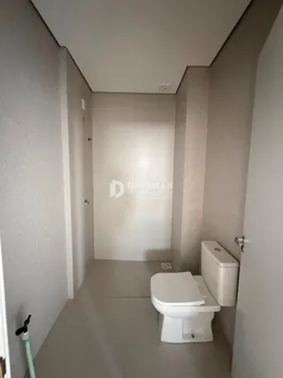 Corredor interno com vaso sanitário em um imóvel no Brasil.
