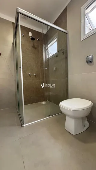 Foto de um banheiro com box de vidro e vaso sanitário em Lajeado.