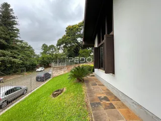 Fachada de uma residência em Lajeado, Brasil, com jardim e cerca.