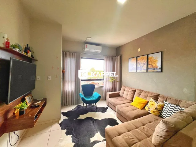 Sala de estar com sofá e televisão em um apartamento.