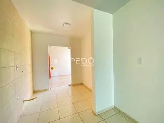 Hall de entrada com piso de cerâmica clara.