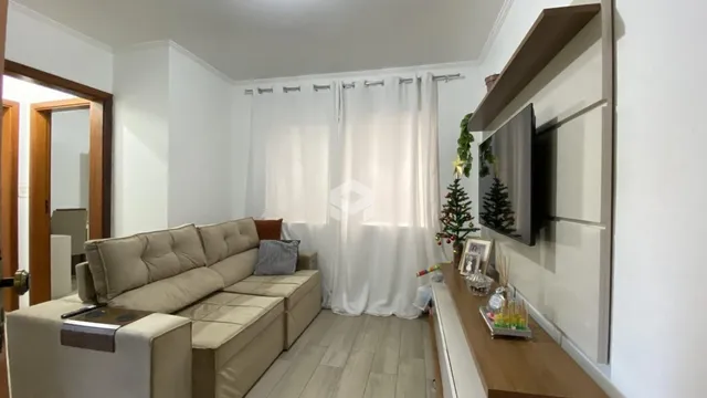 Sala de estar com sofá e decoração clara.