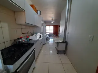 Vista interna de uma cozinha e corredor em um imóvel no Brasil.