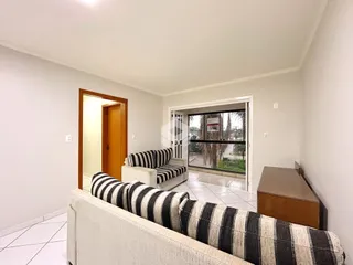 Sala de estar com sofá listrado e porta de madeira visível.