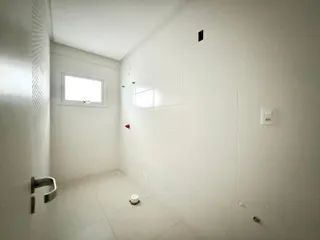 Corredor interno com paredes brancas e piso claro.