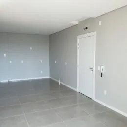 Foto de um ambiente interno com piso de cerâmica e paredes claras.
