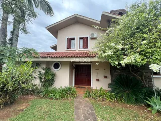 Fachada de uma residência em Lajeado, Brasil, cercada por vegetação.