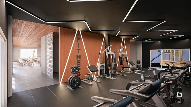 Interior de uma academia com equipamentos de ginástica.